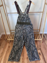 Load image into Gallery viewer, Carhartt Mossy oak tree stand hunting camo vintage overalls men’s size Large/Medium made in USA camo hunting bibs 80s 90s