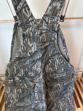 Load image into Gallery viewer, Carhartt Mossy oak tree stand hunting camo vintage overalls men’s size Large/Medium made in USA camo hunting bibs 80s 90s